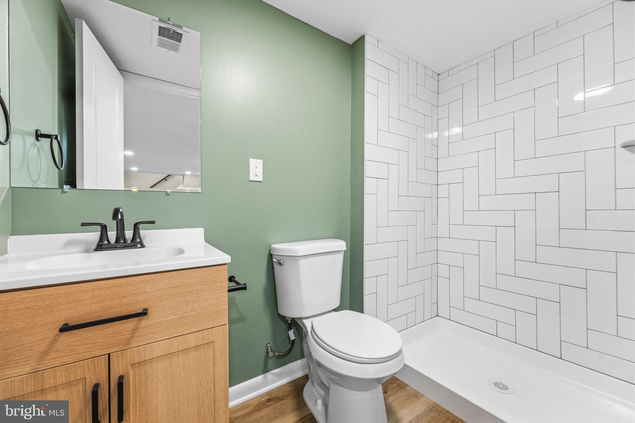 819 Old Harmony Road Newark, DE 19711 - Photo 14 of 39 a bathroom with a sink a toilet and shower