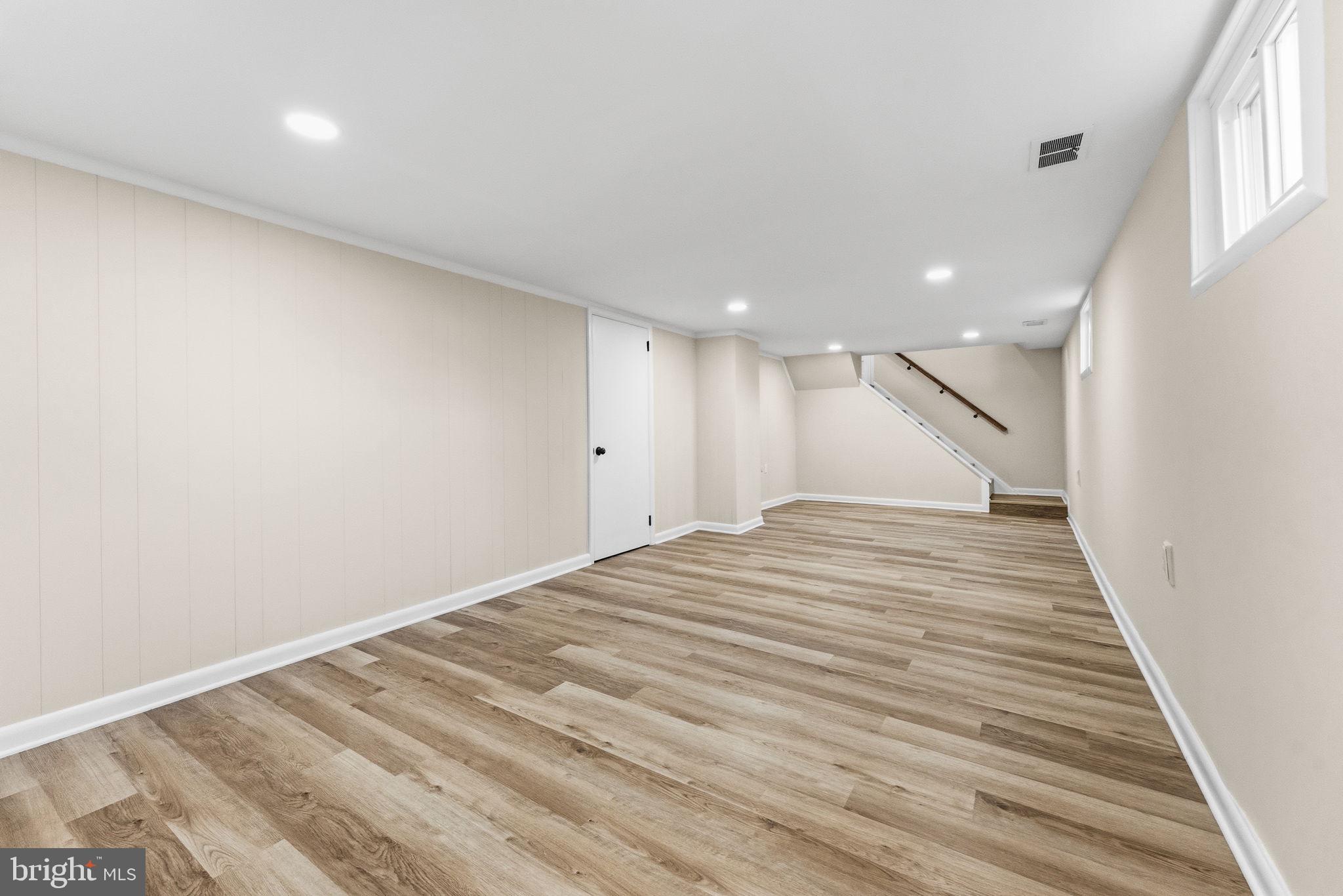 819 Old Harmony Road Newark, DE 19711 - Photo 22 of 39 a view of a big room with wooden floor and stairs