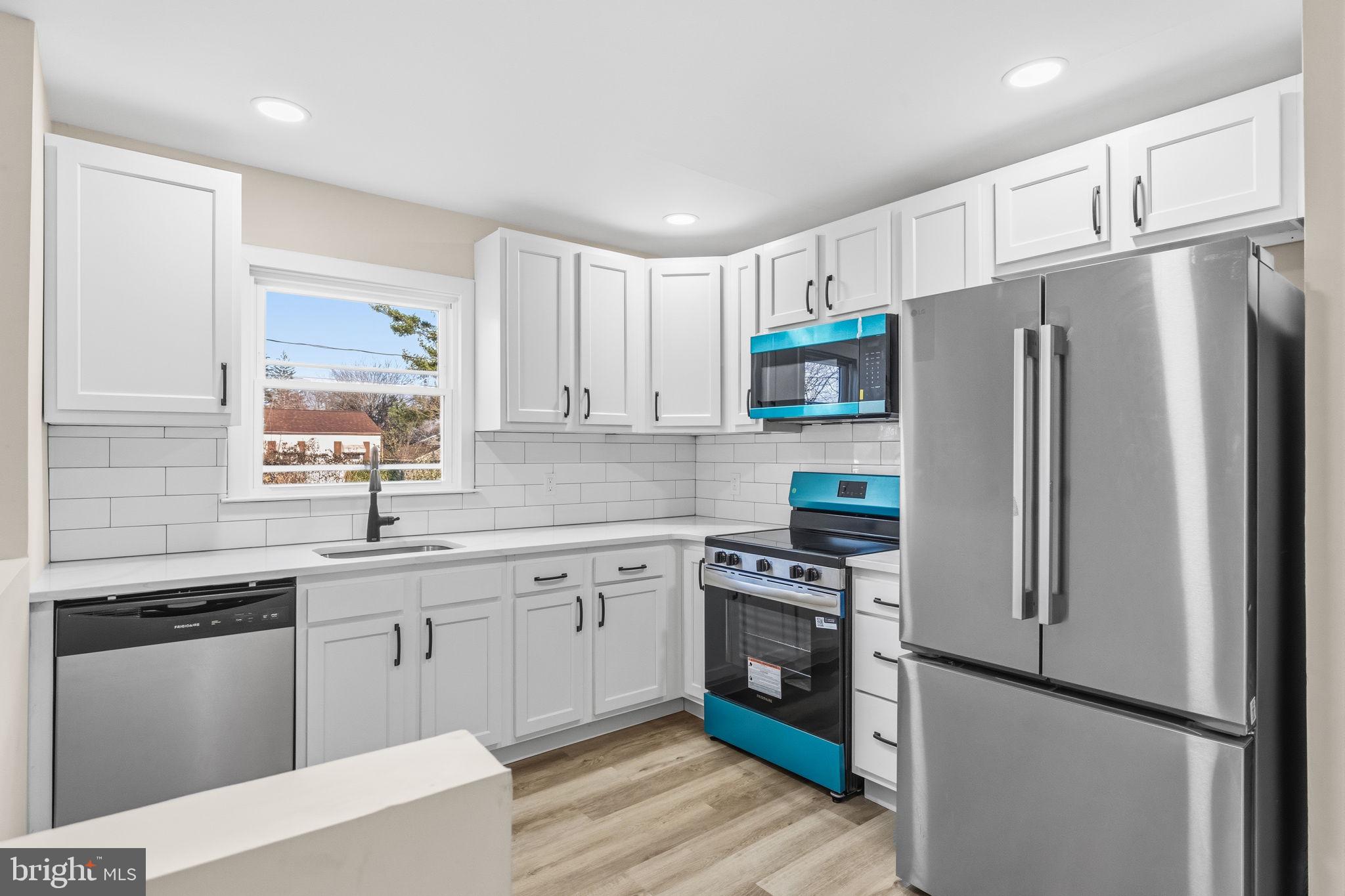 819 Old Harmony Road Newark, DE 19711 - Photo 7 of 39 a kitchen with stainless steel appliances a refrigerator stove and sink