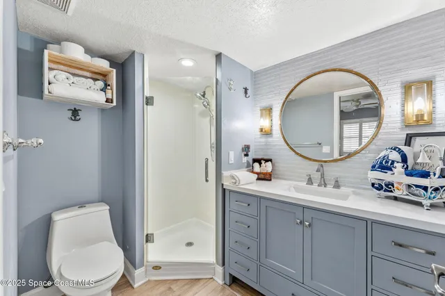 a bathroom with a toilet a sink a mirror and vanity