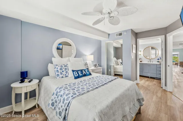 a bedroom with a bed and a mirror