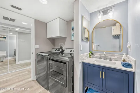 a spacious bathroom with a granite countertop sink a mirror and a shower
