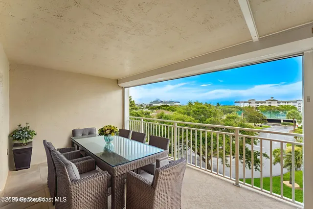 a view of a balcony with a table and chairs