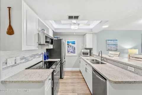 a large kitchen with stainless steel appliances granite countertop a sink and stove