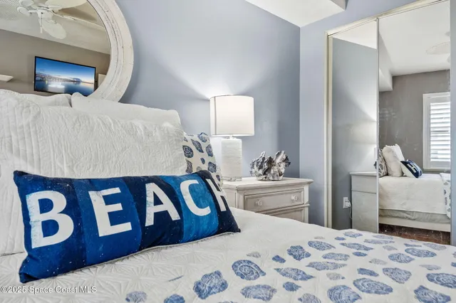 a bedroom with a bed and a lamp