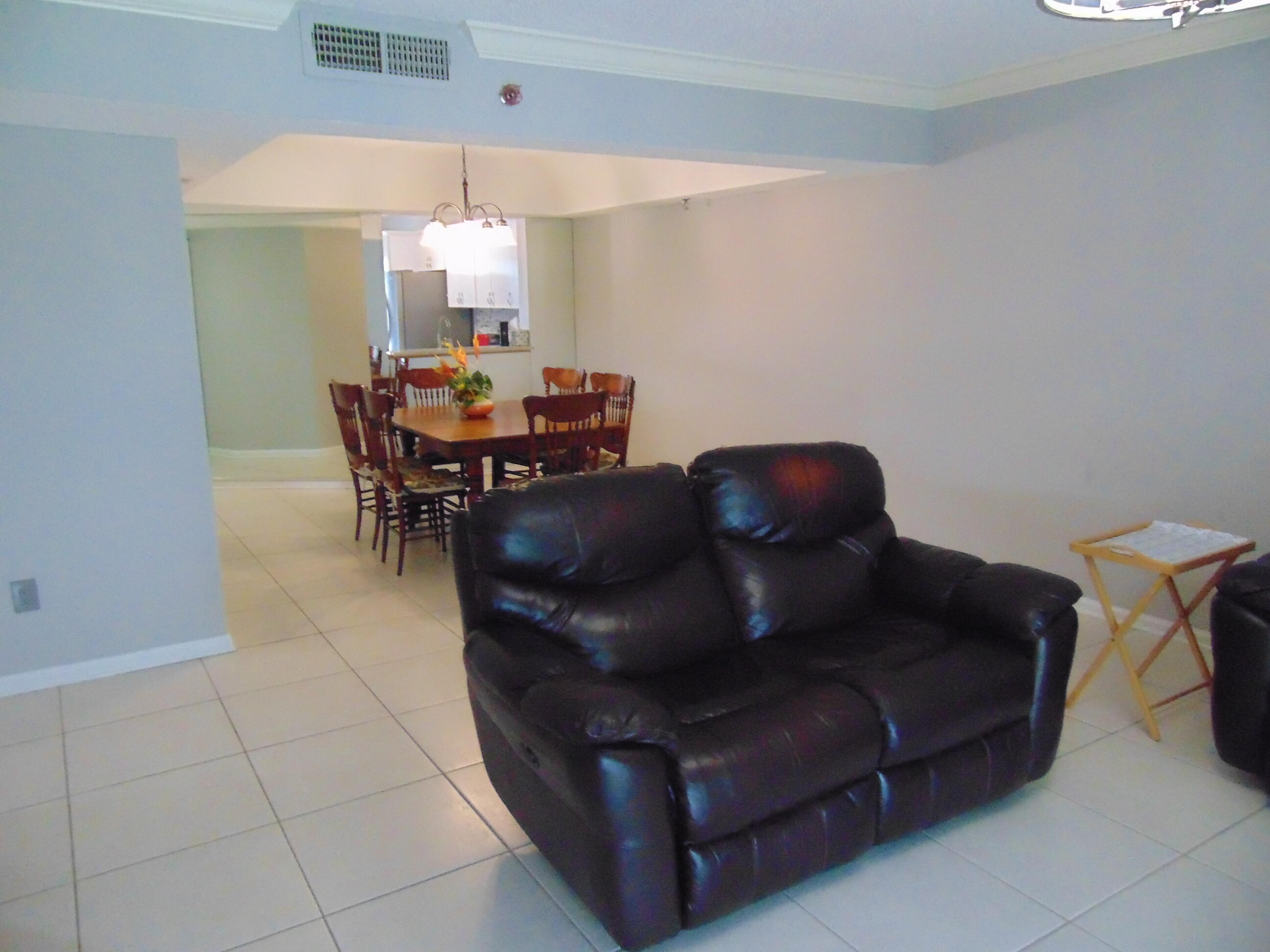 9220 Southwest 14th Street, Unit 3103 Boca Raton, FL 33428 - Photo 24 of 58 a living room with furniture and a dining table