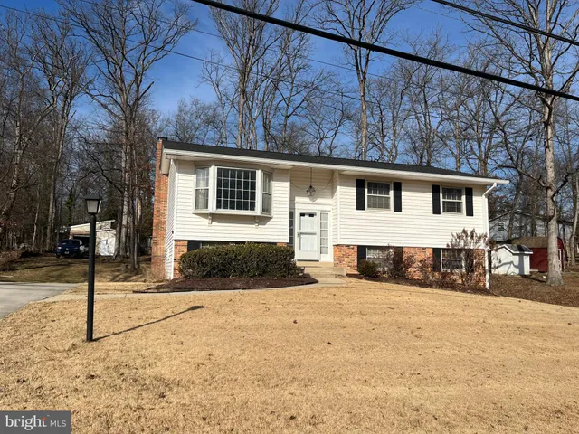 a view of a house with snow on the road