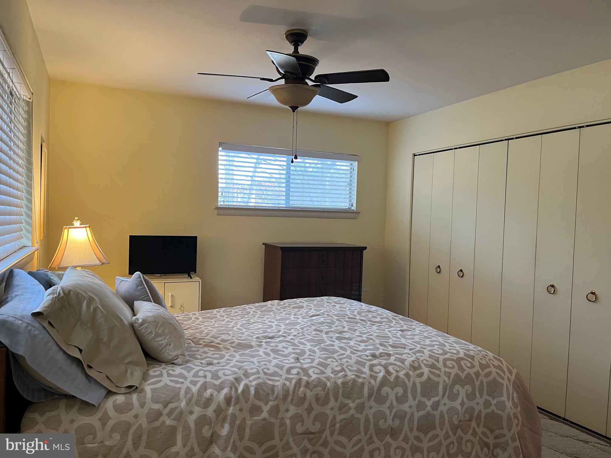 7018 Redmiles Road Laurel, MD 20707 - Photo 11 of 39 a bedroom with a bed and a chandelier