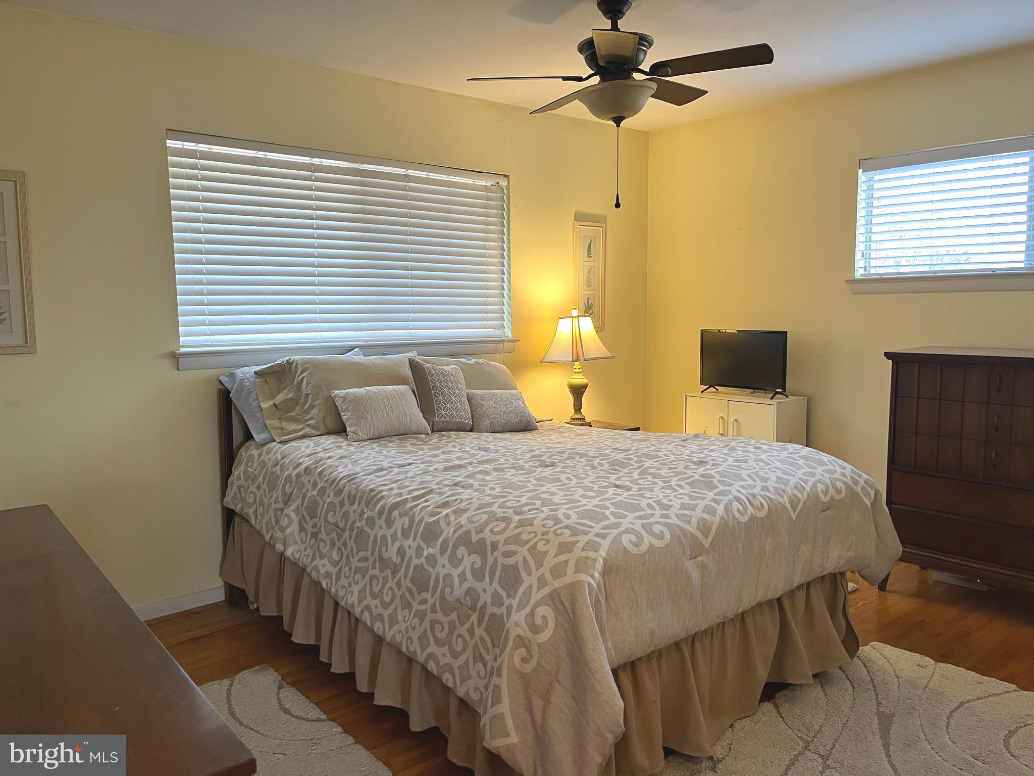 7018 Redmiles Road Laurel, MD 20707 - Photo 12 of 39 a bedroom with a bed and a chandelier