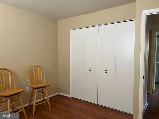 a view of a room with wooden floor and lounge chair