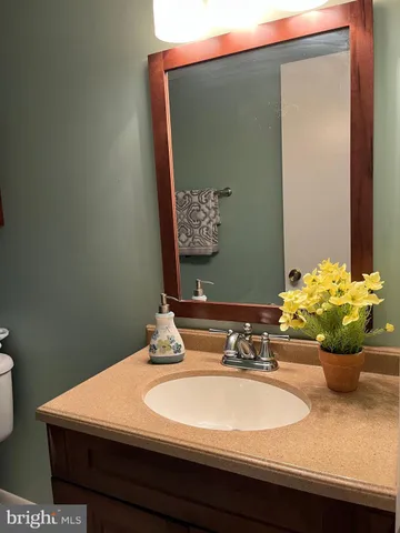 a bathroom with a sink a vanity and a mirror