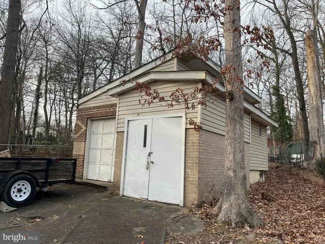 a front view of a house with a tree