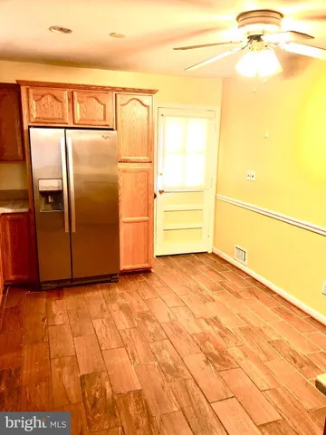a view of a room with wooden floor
