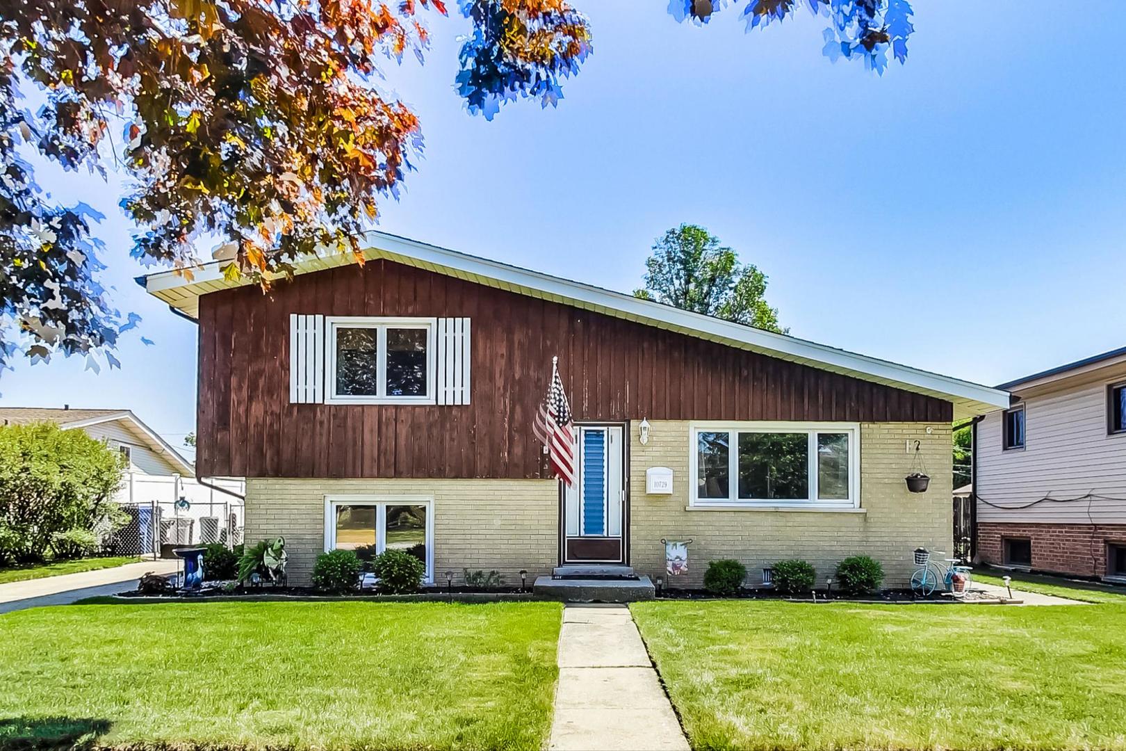 10729 Rutherford Avenue Worth, IL 60482 - Photo 1 of 22 a front view of a house with a yard