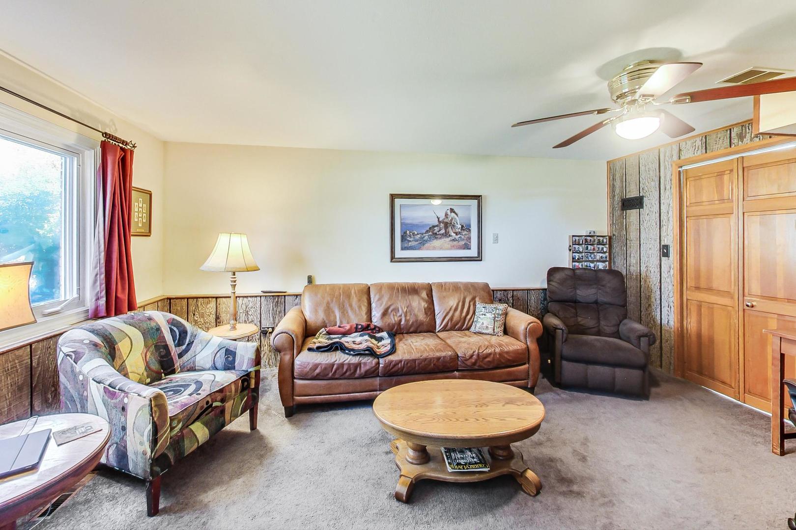 10729 Rutherford Avenue Worth, IL 60482 - Photo 16 of 22 a living room with furniture a lamp a rug and a window