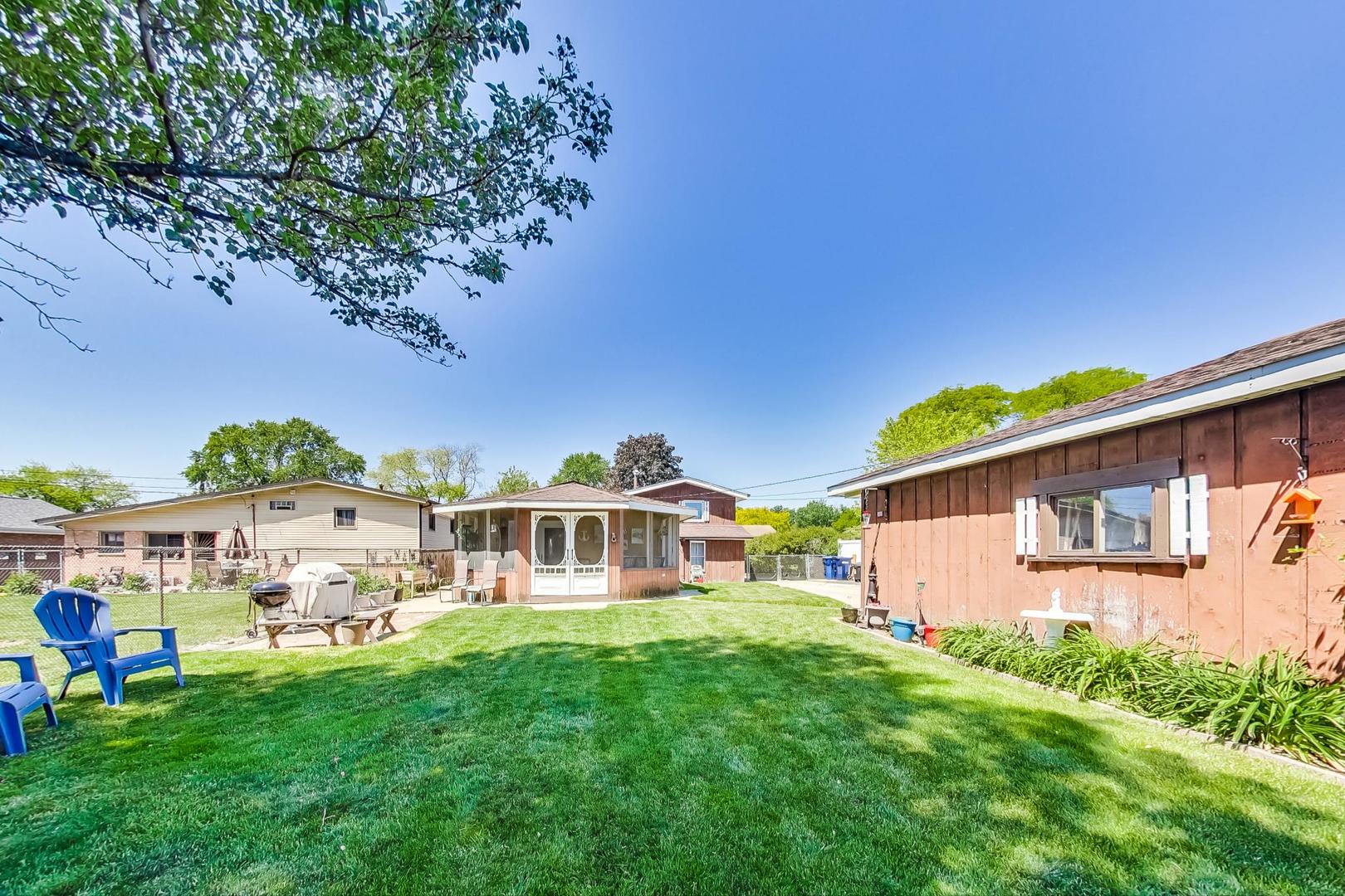10729 Rutherford Avenue Worth, IL 60482 - Photo 21 of 22 a view of a house with backyard and a sitting area