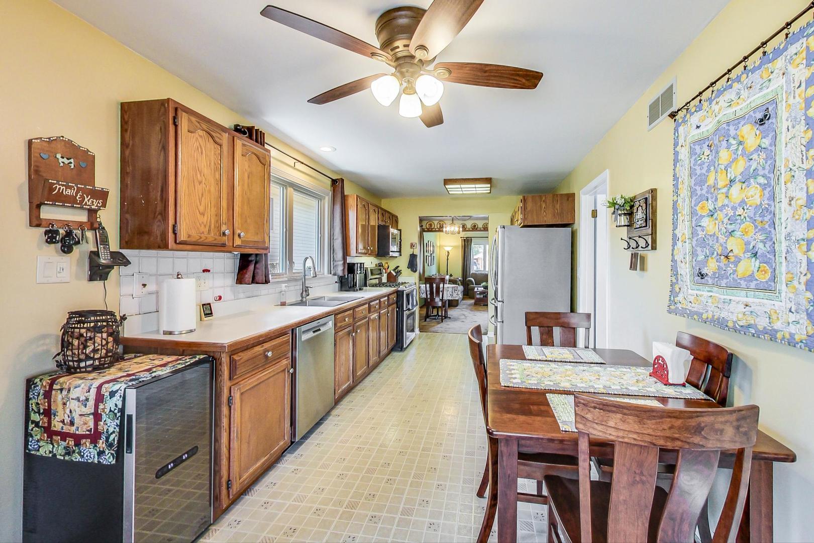 10729 Rutherford Avenue Worth, IL 60482 - Photo 9 of 22 a large kitchen with a table and chairs