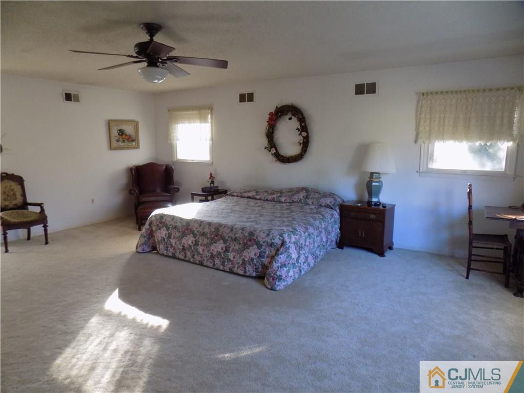 28 Taylor Road Princeton, NJ 08540 - Photo 11 of 24 a bedroom with bed and a chandelier
