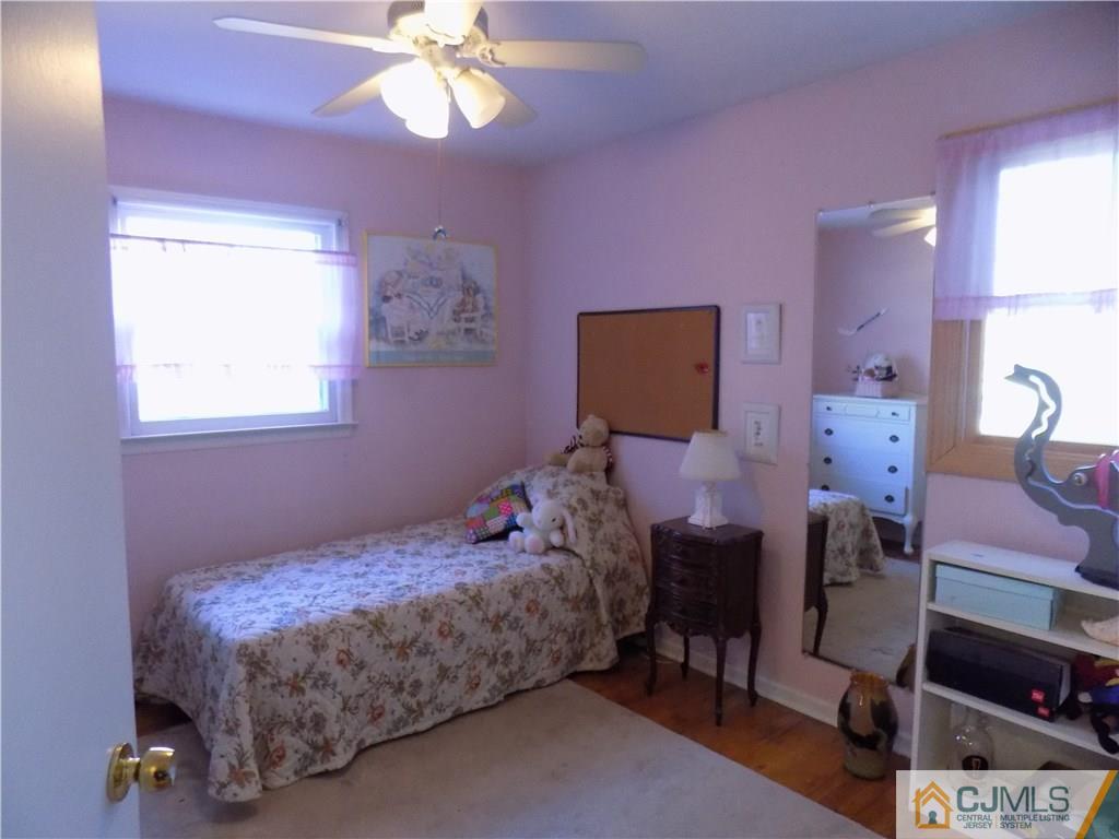 28 Taylor Road Princeton, NJ 08540 - Photo 13 of 24 a bedroom with a bed and a chandelier