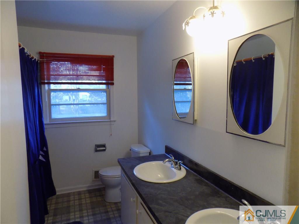 28 Taylor Road Princeton, NJ 08540 - Photo 23 of 24 a bathroom with a granite countertop toilet a sink and mirror