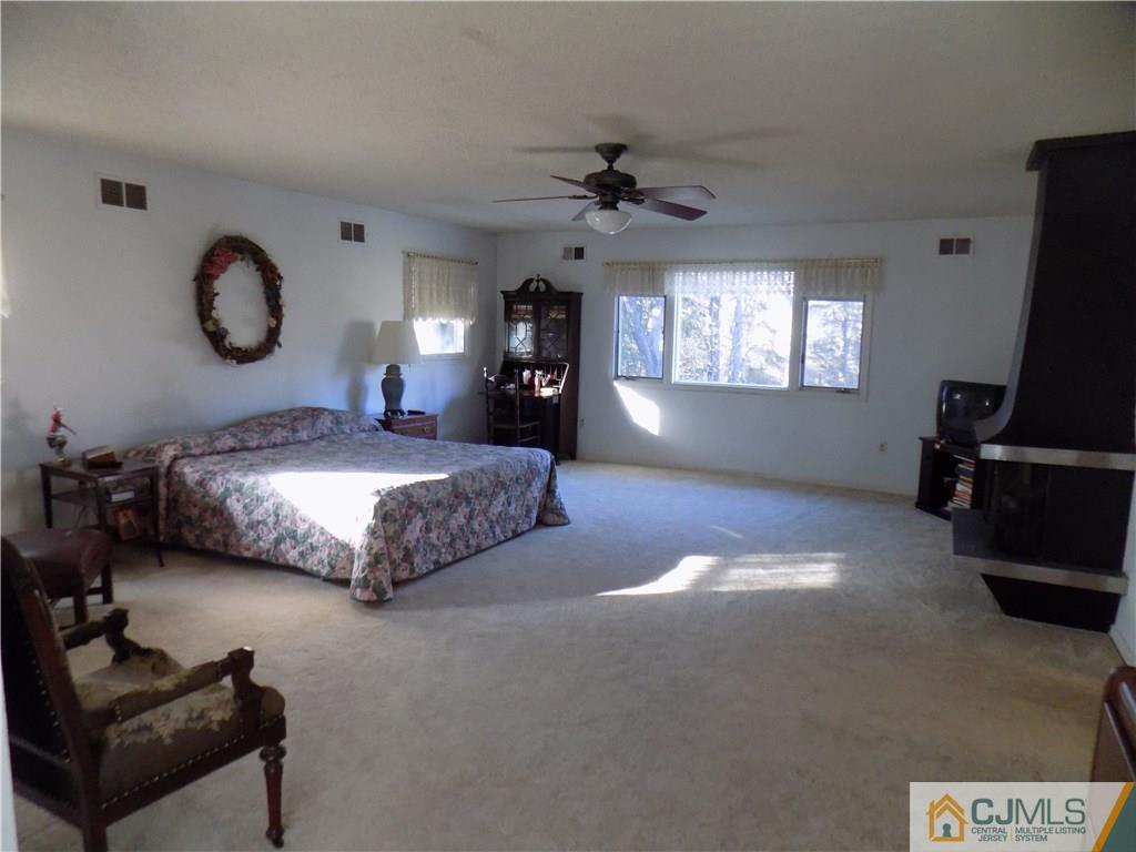 28 Taylor Road Princeton, NJ 08540 - Photo 6 of 24 a spacious bedroom with a bed and a flat screen tv