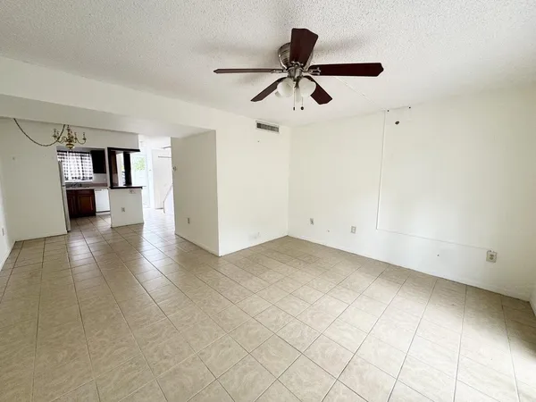 a view of a livingroom with a ceiling fan and window