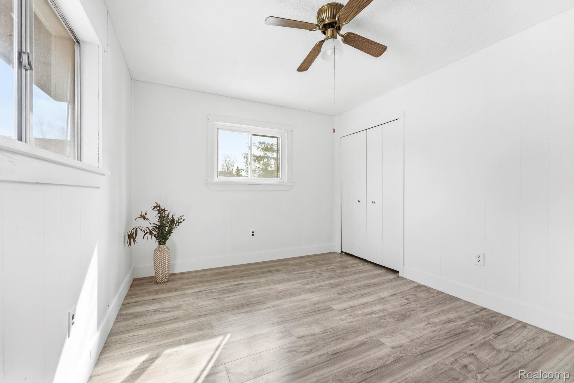 3375 Grant Road Rochester, MI 48309 - Photo 21 of 28 Unfurnished bedroom featuring light wood finished floors, ceiling fan, and a closet