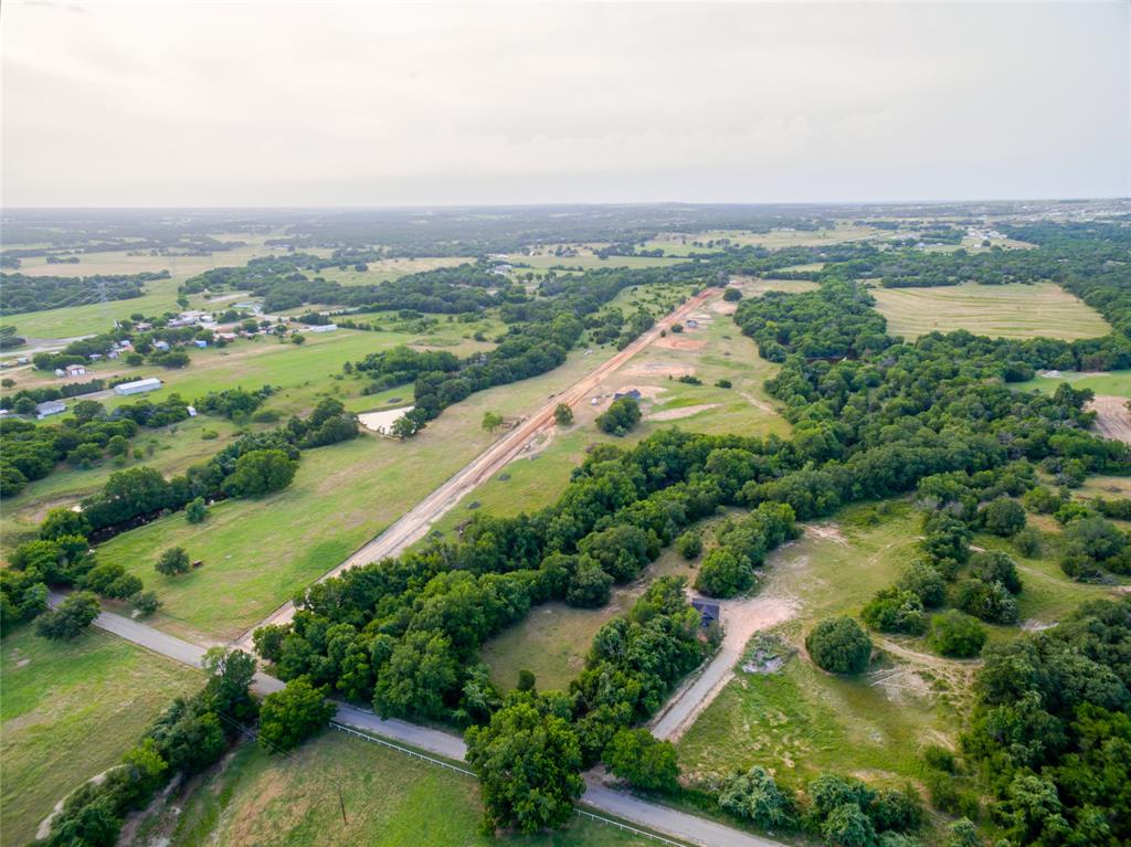 1040 Rays Way Weatherford, TX 76085 - Photo 2 of 5 an aerial view of lake residential house with outdoor space and trees around