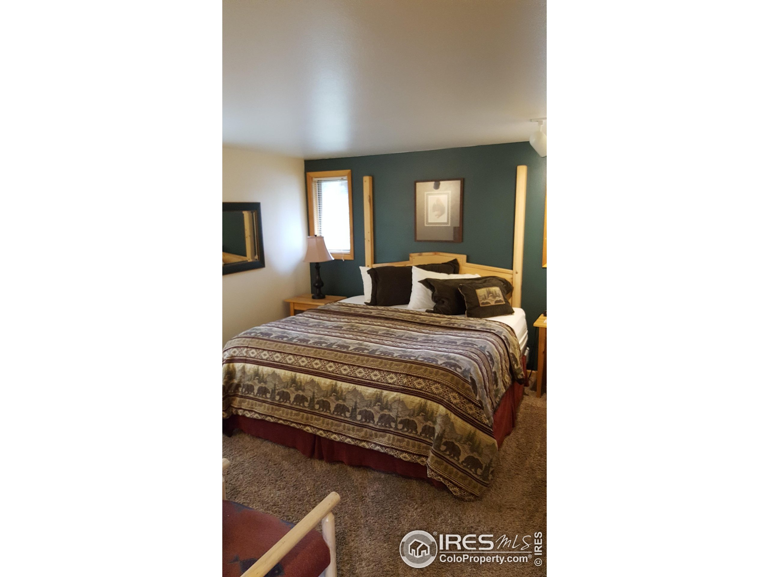 1565 Highway 66, Unit 46 Estes Park, CO 80517 - Photo 7 of 21 a bedroom with a bed and a window