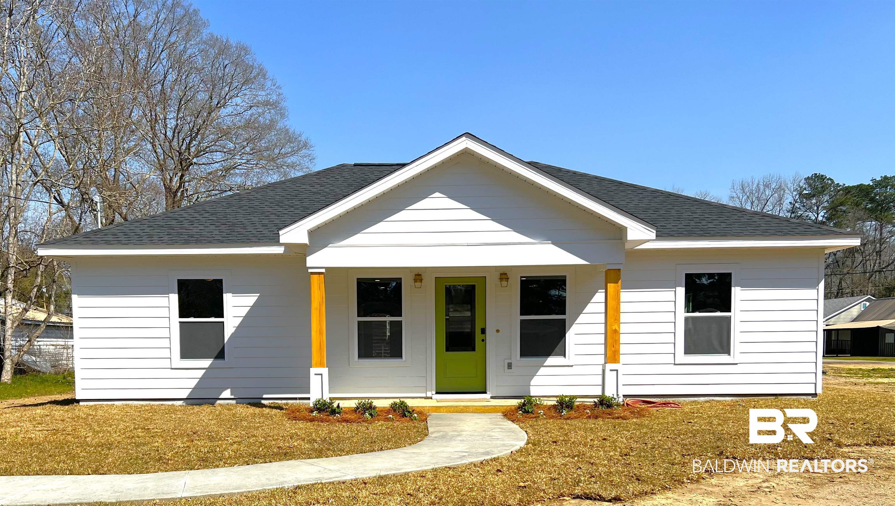 102 Earl Street Brewton, AL 36426 - Photo 16 of 27 View of front of home featuring a shingled roof, a front yard, and covered porch