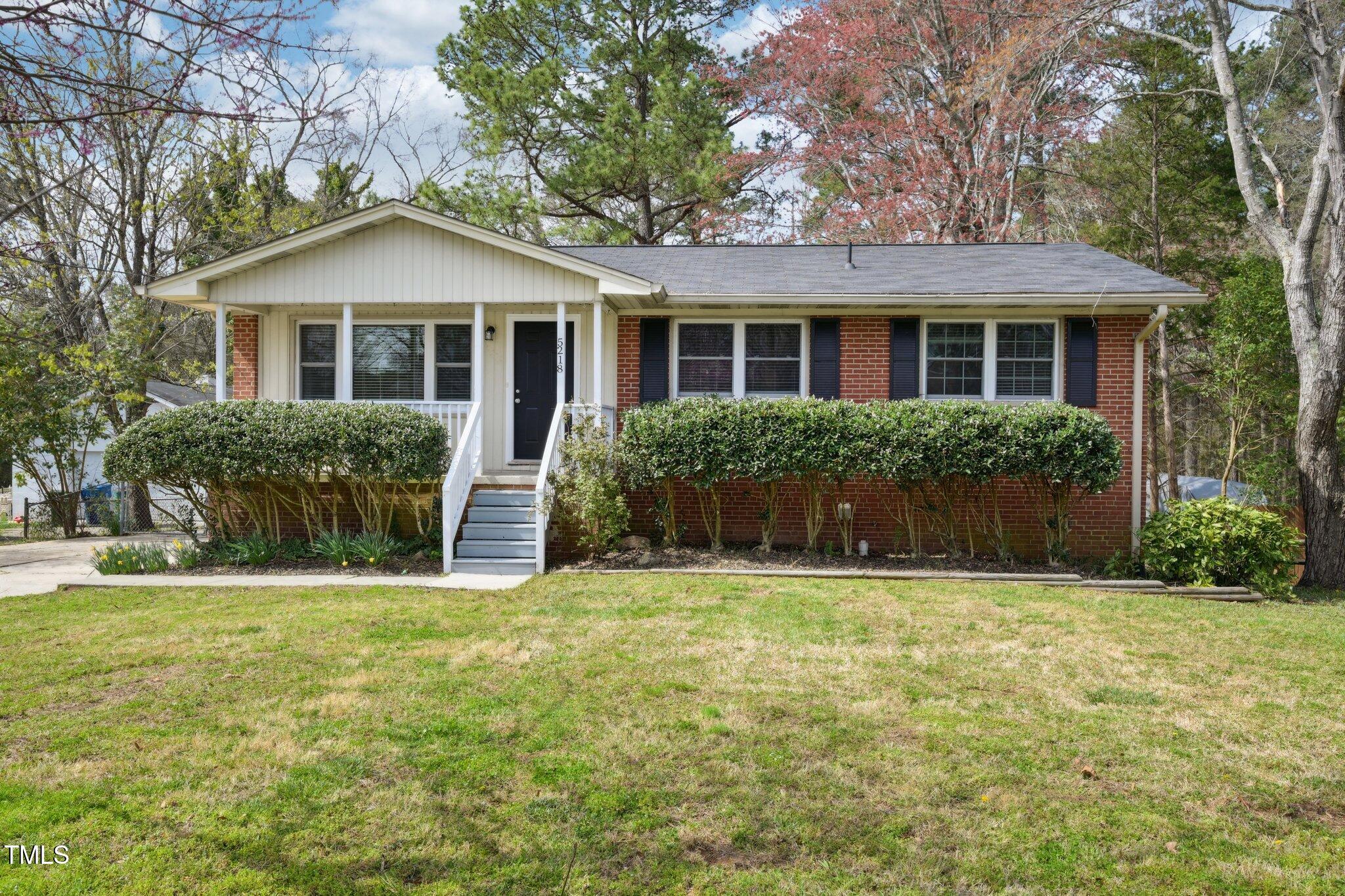 5218 Revere Road Durham, NC 27713 - Photo 1 of 46 a front view of house with yard and green space