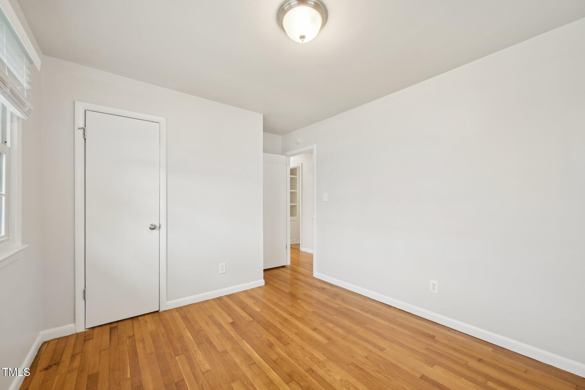 5218 Revere Road Durham, NC 27713 - Photo 22 of 46 a view of empty room with wooden floor