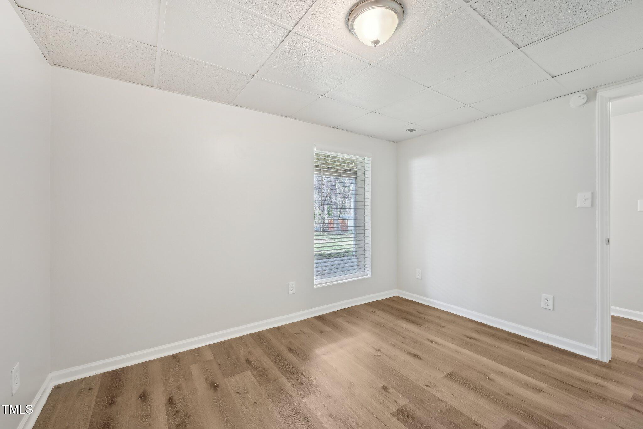 5218 Revere Road Durham, NC 27713 - Photo 28 of 46 an empty room with wooden floor and windows