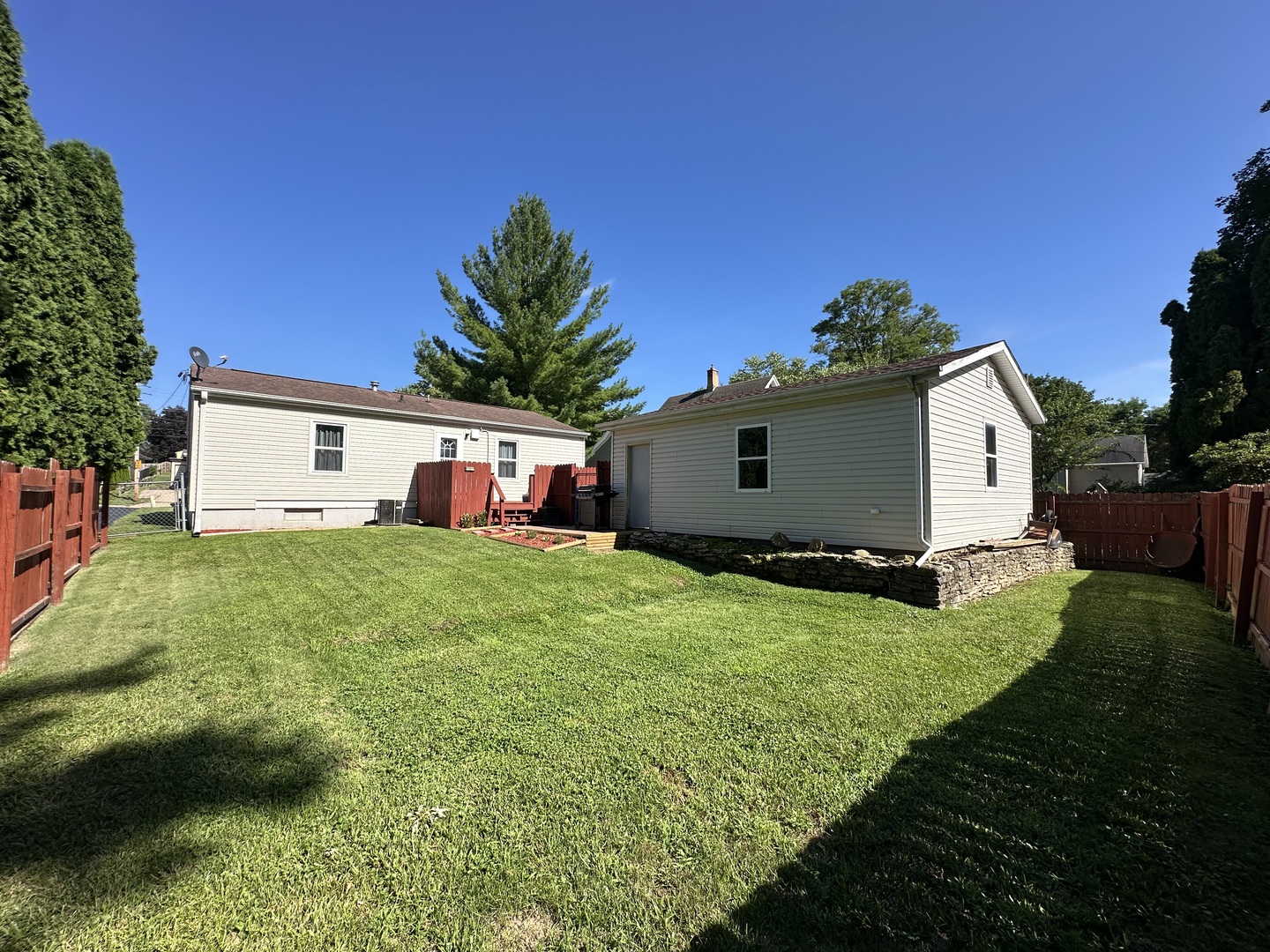 623 4th Avenue Dixon, IL 61021 - Photo 17 of 19 a view of a white house with a big yard plants and large trees