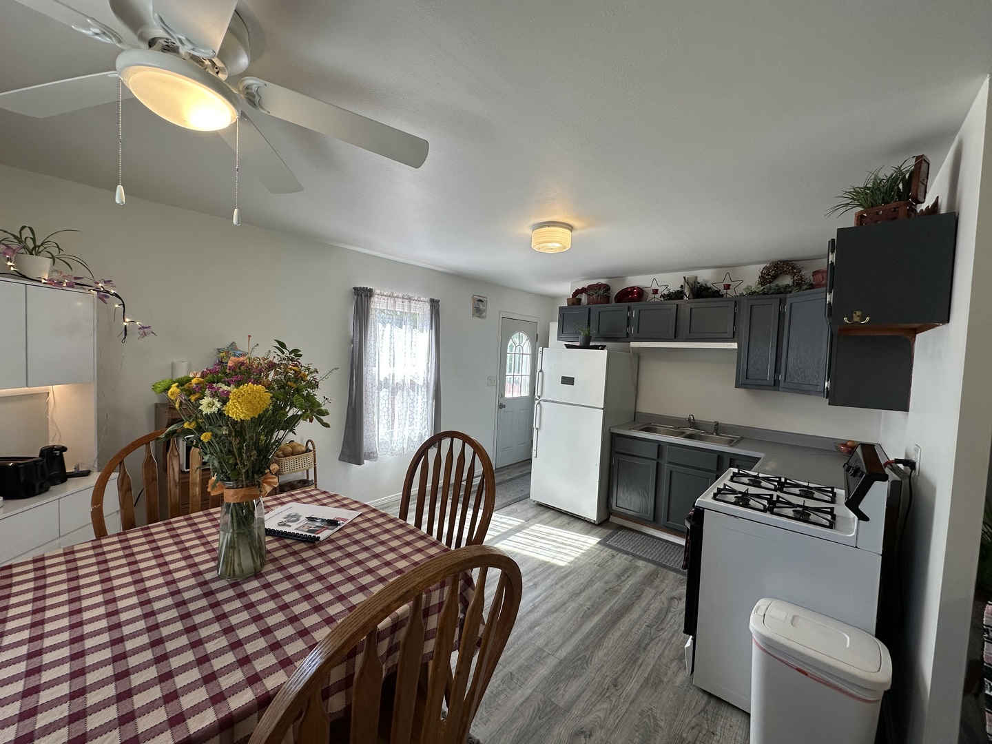 623 4th Avenue Dixon, IL 61021 - Photo 6 of 19 a kitchen with stainless steel appliances granite countertop a stove a sink a dining table and chairs with wooden floor