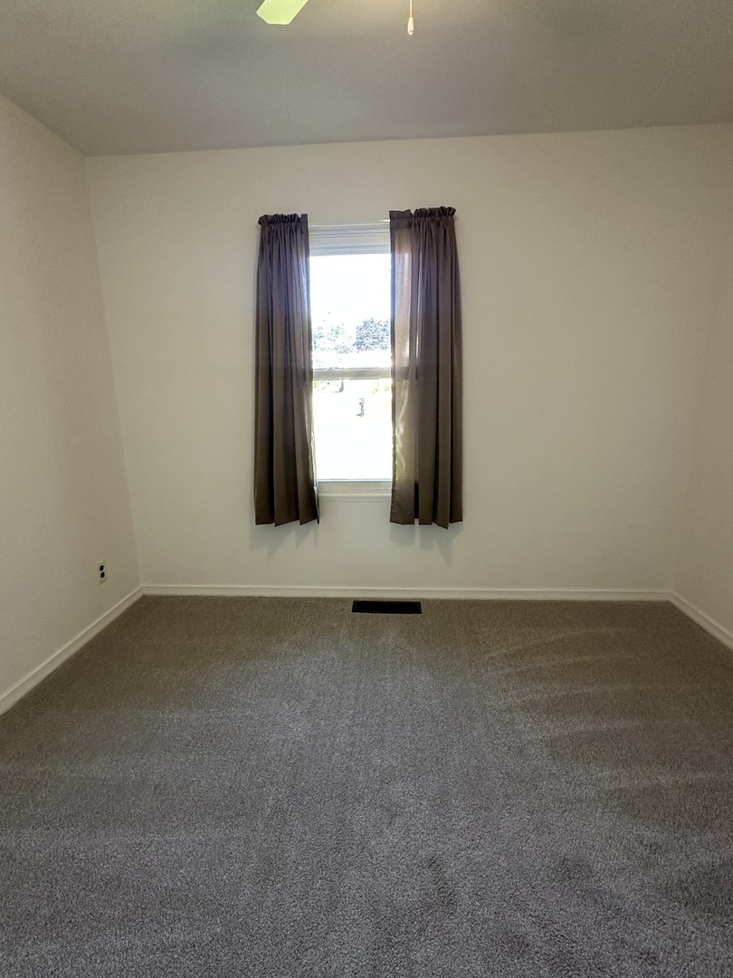 623 4th Avenue Dixon, IL 61021 - Photo 8 of 19 a view of wooden floor and windows in a room