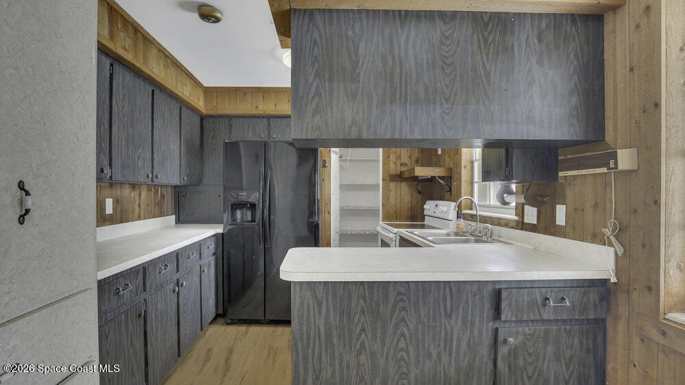 850 Cardinal Road Cocoa, FL 32926 - Photo 20 of 41 a kitchen with a sink a stove and cabinets