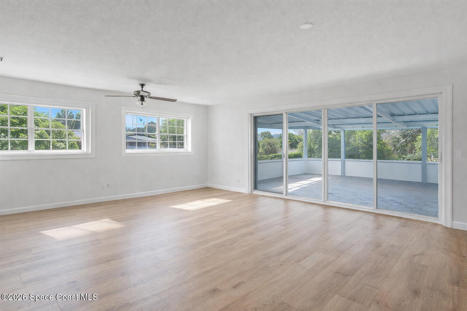 850 Cardinal Road Cocoa, FL 32926 - Photo 4 of 41 an empty room with wooden floor and windows