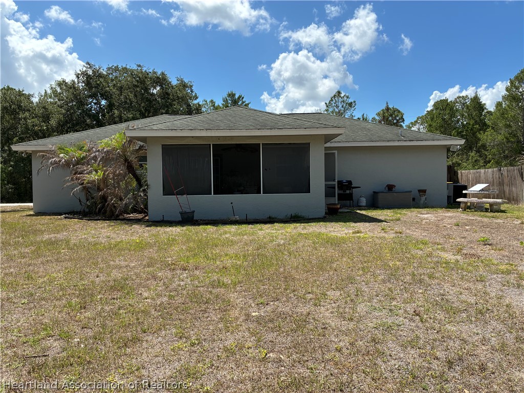 922 Breezy Road Lake Placid, FL 33852 - Photo 2 of 18 a front view of a house with a garden