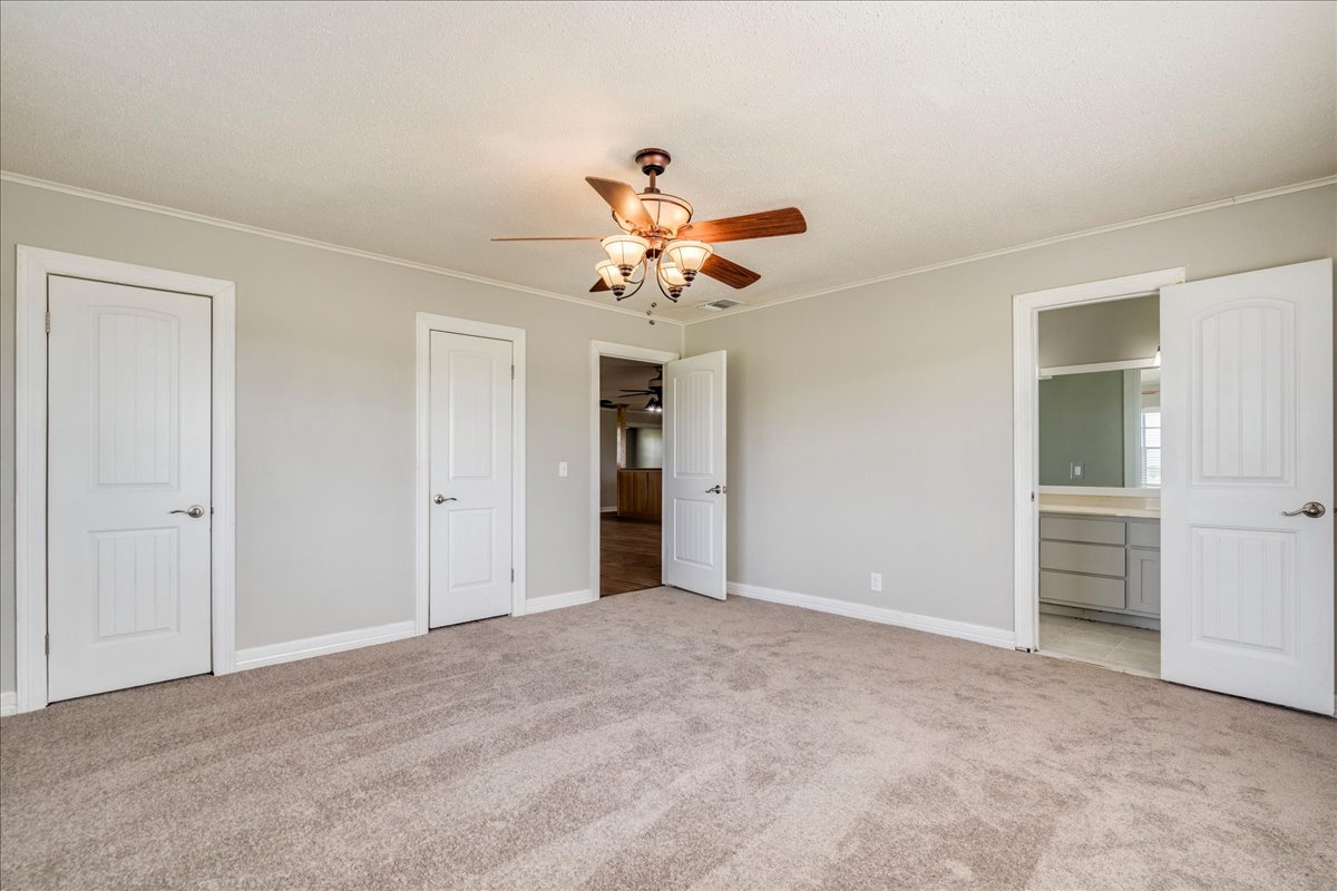 595 Cardinal Road Rosanky, TX 78953 - Photo 19 of 39 a view of an empty room with a ceiling fan
