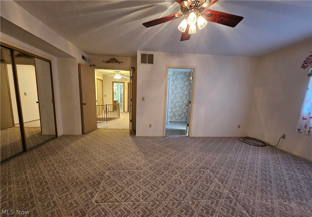 16551 Drake Road Strongsville, OH 44136 - Photo 37 of 50 Master Bedroom featuring light carpet, a dual closet with hidden attic storage entranceand ceiling fan light