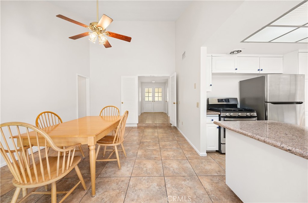 3430 Bahia Place Riverside, CA 92507 - Photo 15 of 34 a kitchen with stainless steel appliances granite countertop a table and chairs