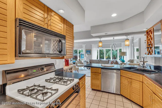 a kitchen with a sink stove and cabinets