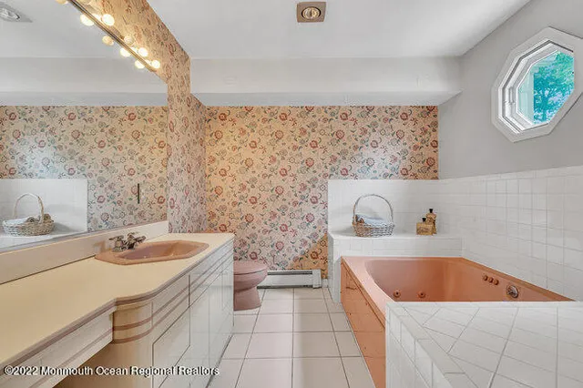 a bathroom with a sink a bathtub and a window