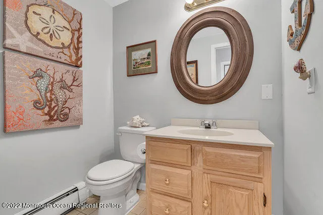 a bathroom with a toilet a sink and a mirror