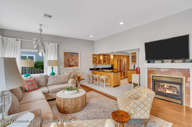 52 Morris Avenue Manasquan, NJ 08736 - Photo 8 of 20 a living room with furniture a flat screen tv and a fireplace