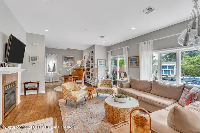 a living room with furniture a flat screen tv and a large window