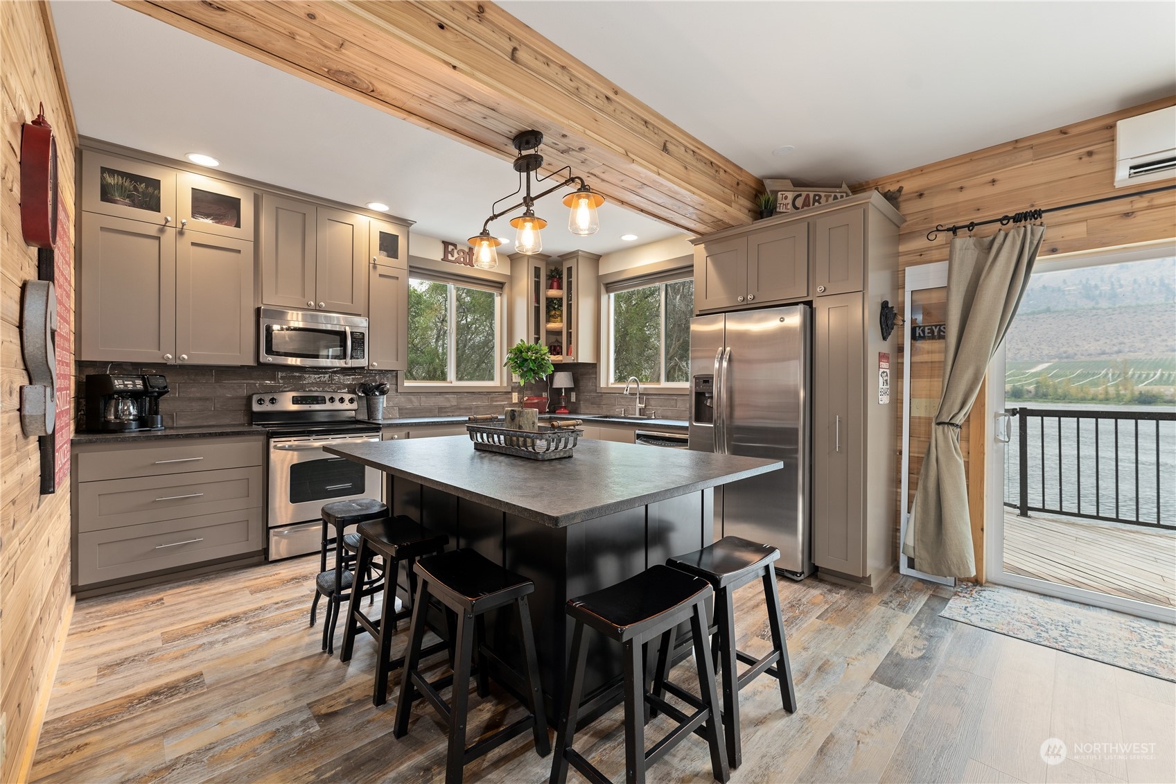 3755 Stayman Flats Road Chelan, WA 98816 - Photo 7 of 39 a kitchen with stainless steel appliances a dining table and chairs