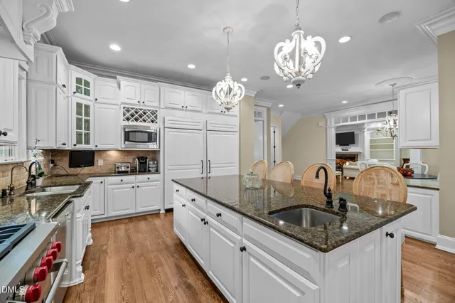 a kitchen with stainless steel appliances a refrigerator sink and stove