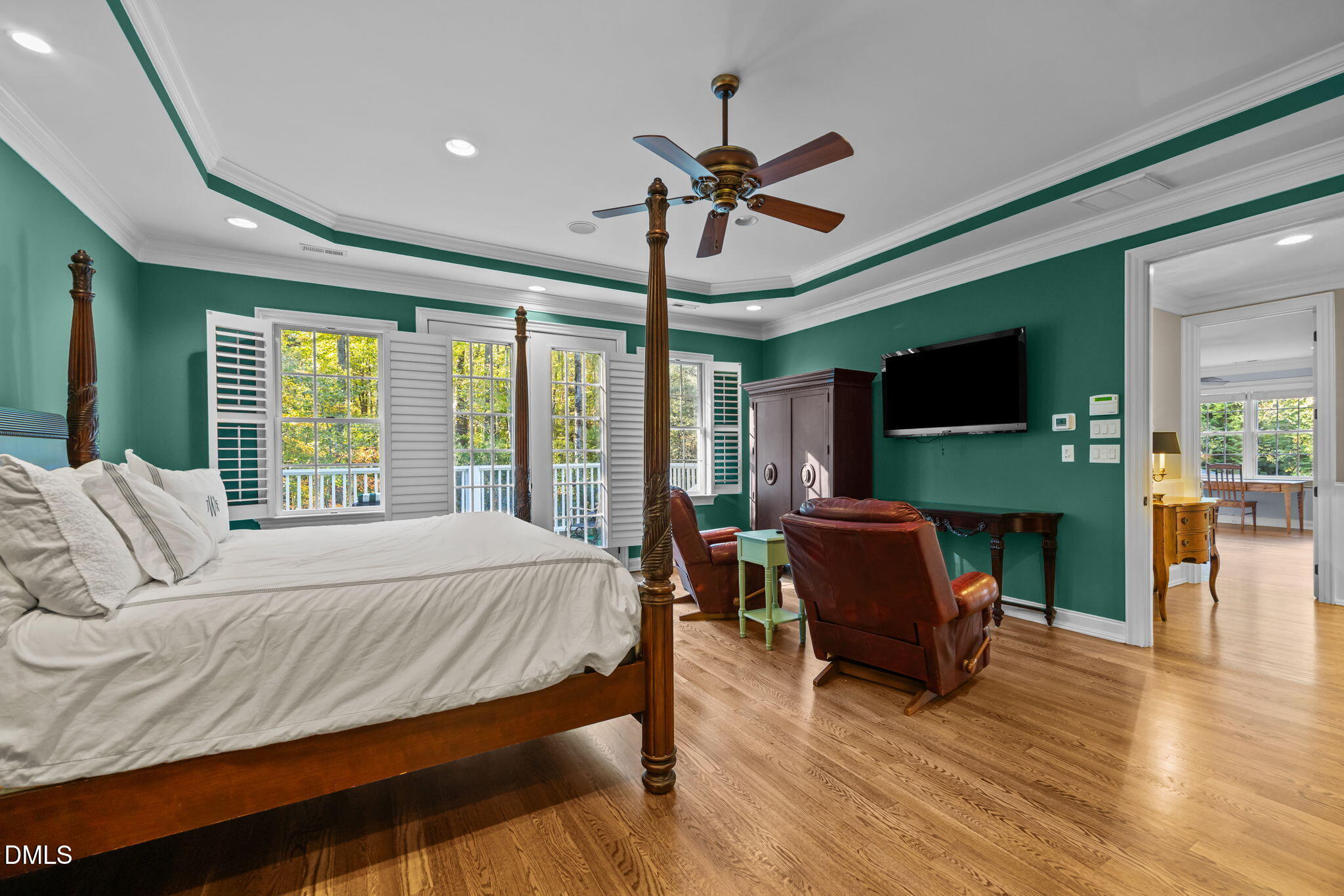 116 Carramore Lane Durham, NC 27705 - Photo 29 of 56 a bedroom with a bed a flat screen tv and a fireplace
